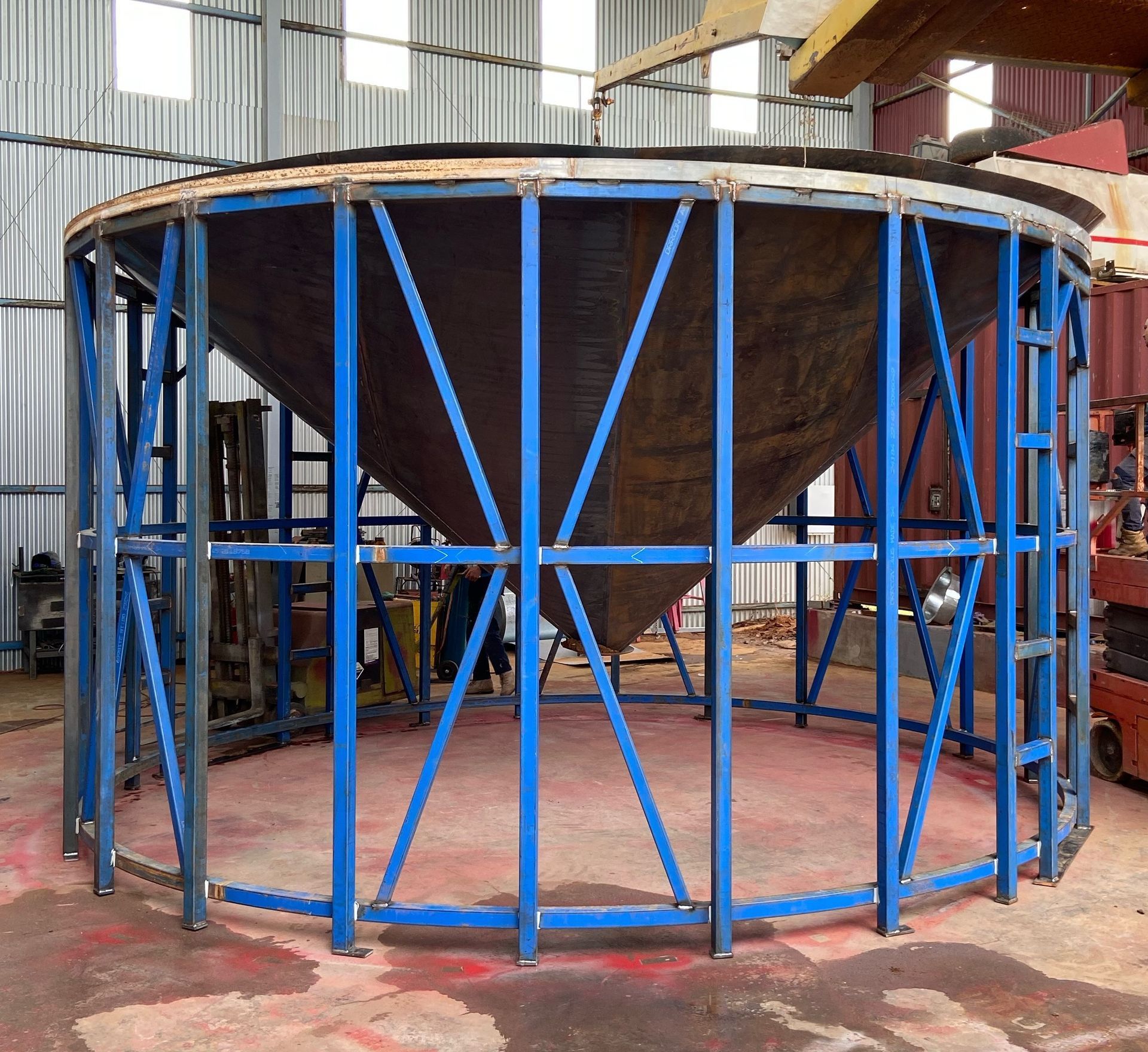 A Large Metal Cone is Surrounded by Blue Metal Frames — Welders In Gilgandra, NSW