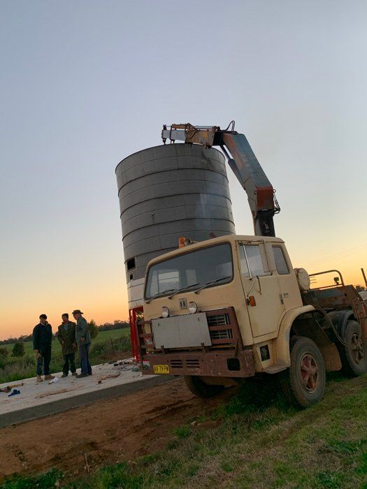 Three Men Infront Of Silo And Truck — Welders In Gilgandra, NSW
