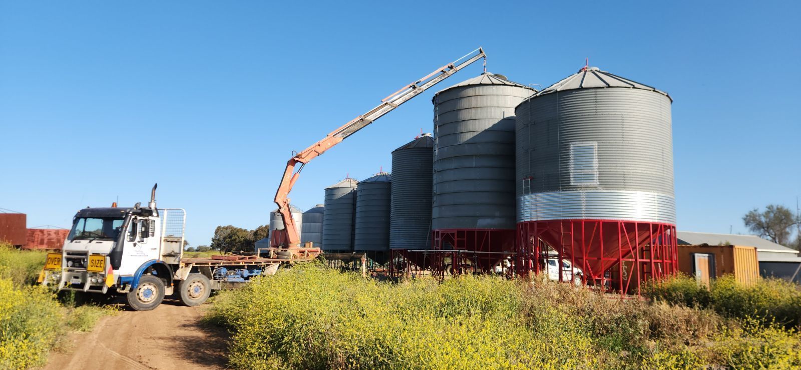 A Truck is Being Loaded With Grain by a Crane — Welders In Gilgandra, NSW