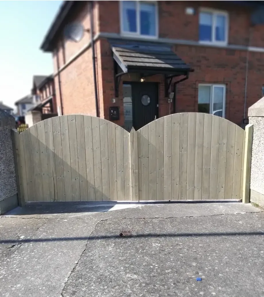 A brick house with a wooden gate in front of it