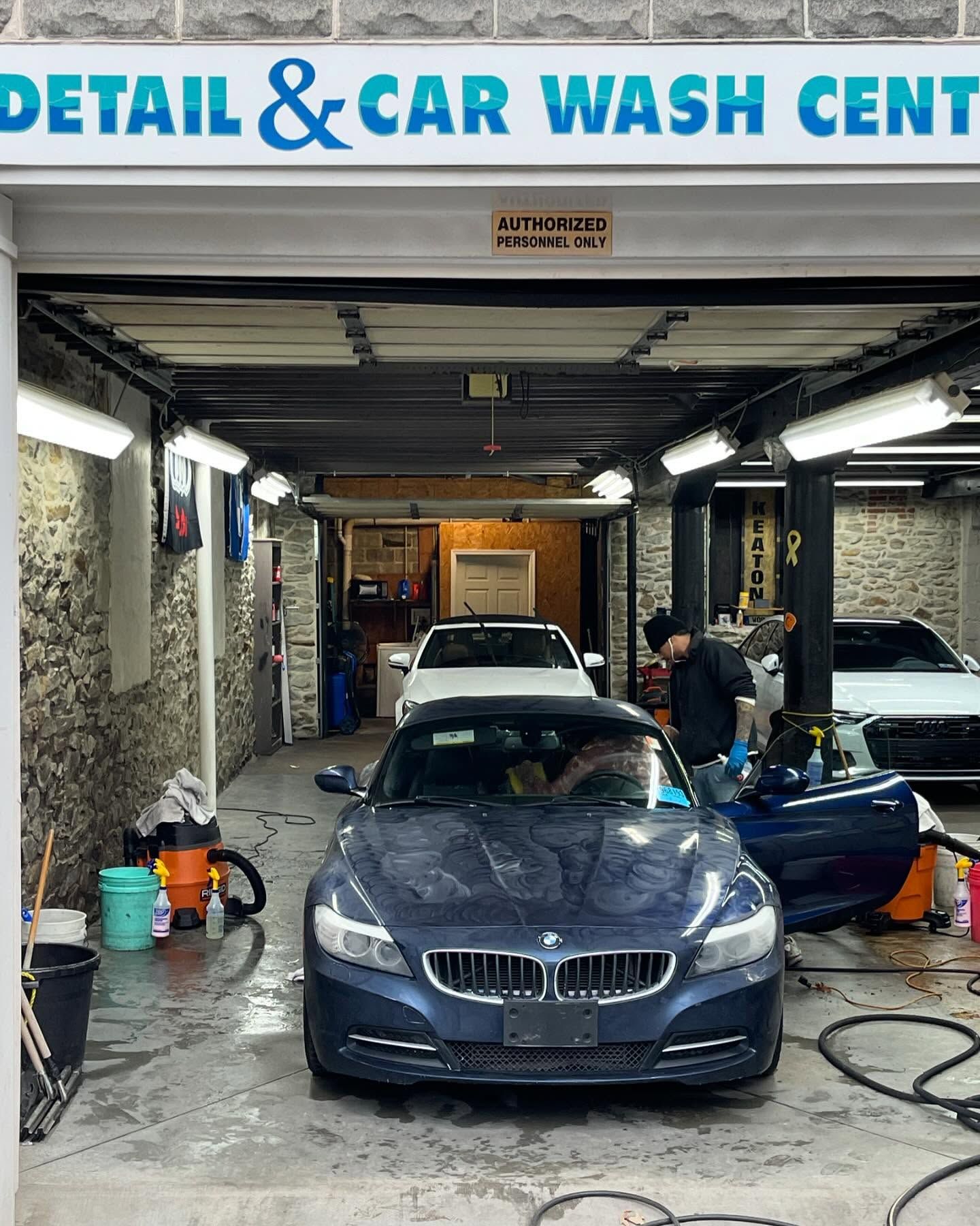 A car is being washed at a detail and car wash center.