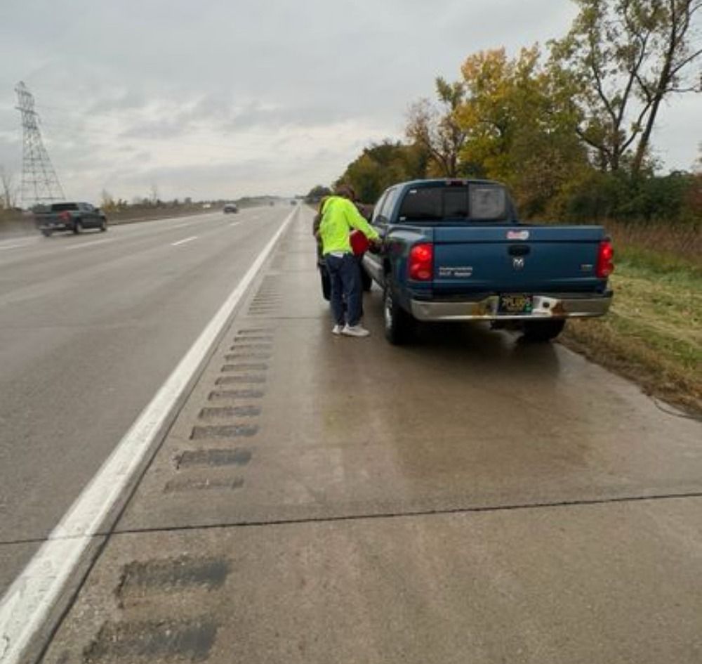 filling up a vehicle with gas on the freeway