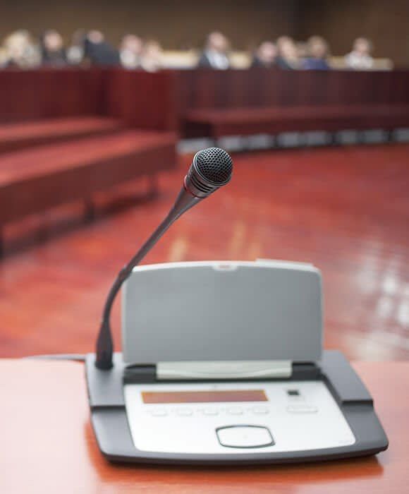 A microphone is sitting on a table in a conference room