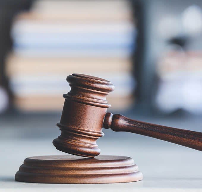 A wooden judge 's gavel is sitting on a table.