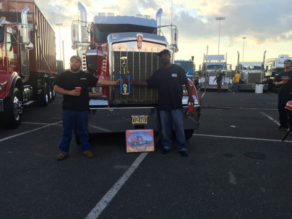 Proud Employees Holding Trophy — Freehold, NJ — Beacon Scrap Iron and Metal Co.