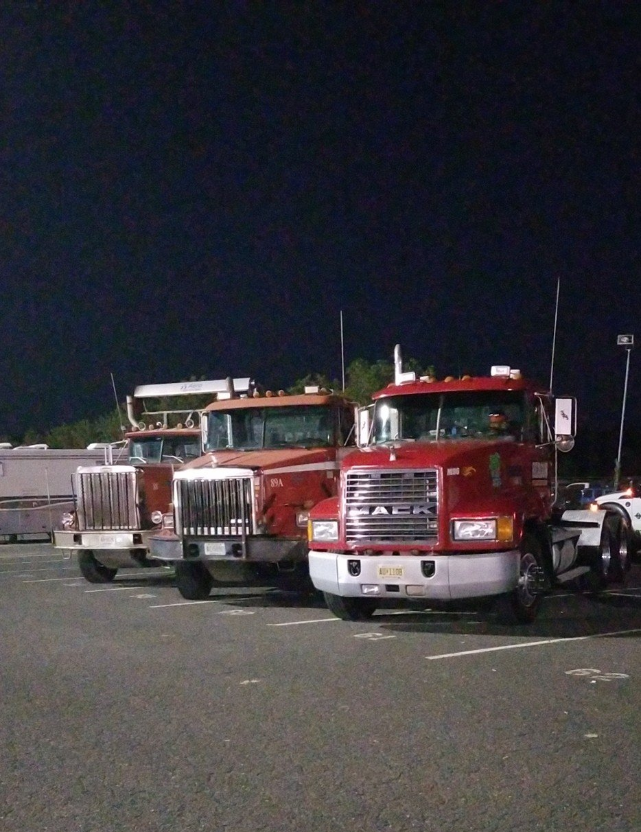 Parked Red Trailer Trucks — Freehold, NJ — Beacon Scrap Iron and Metal Co.