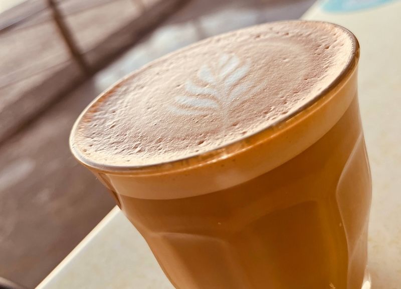 A latte coffee in front of the beach — Beach Bums Cafe In Forster, NSW
