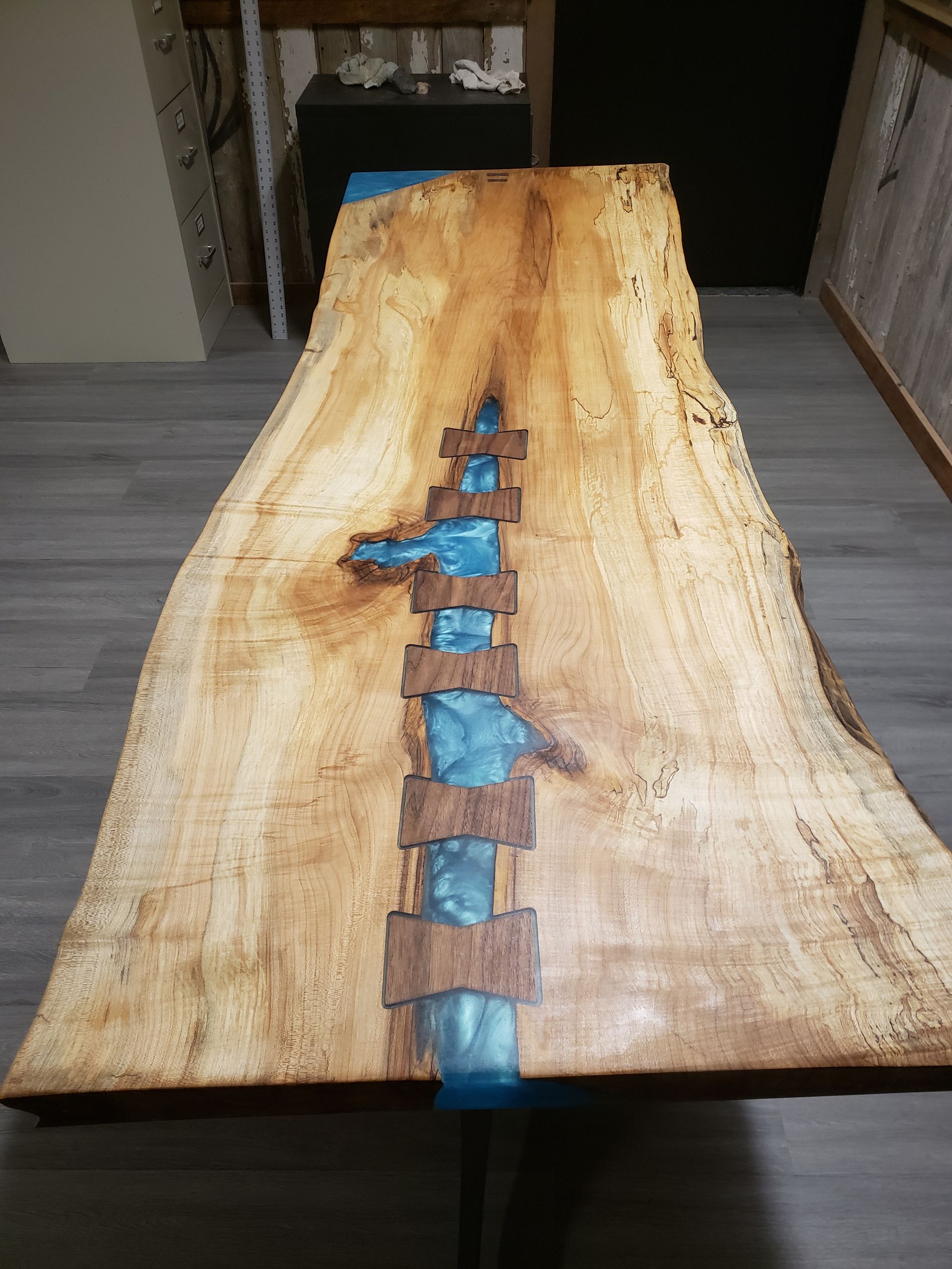 Full size custom epoxy pour table with joins, top view