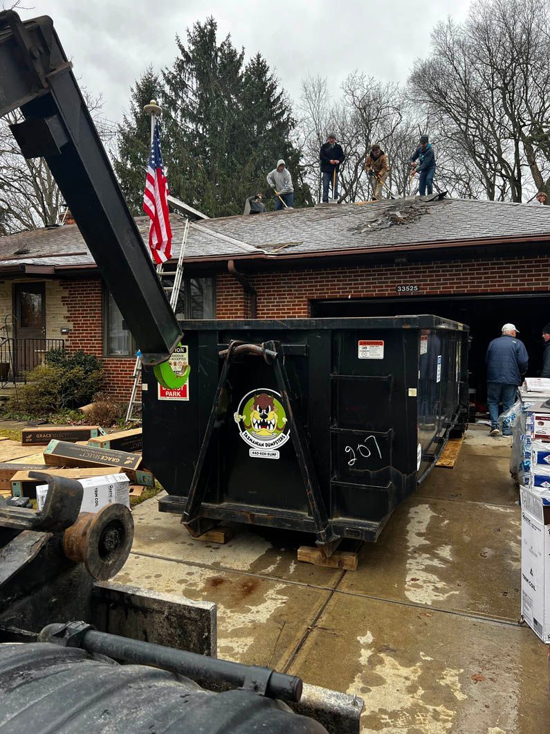 A dumpster is sitting in front of a house.