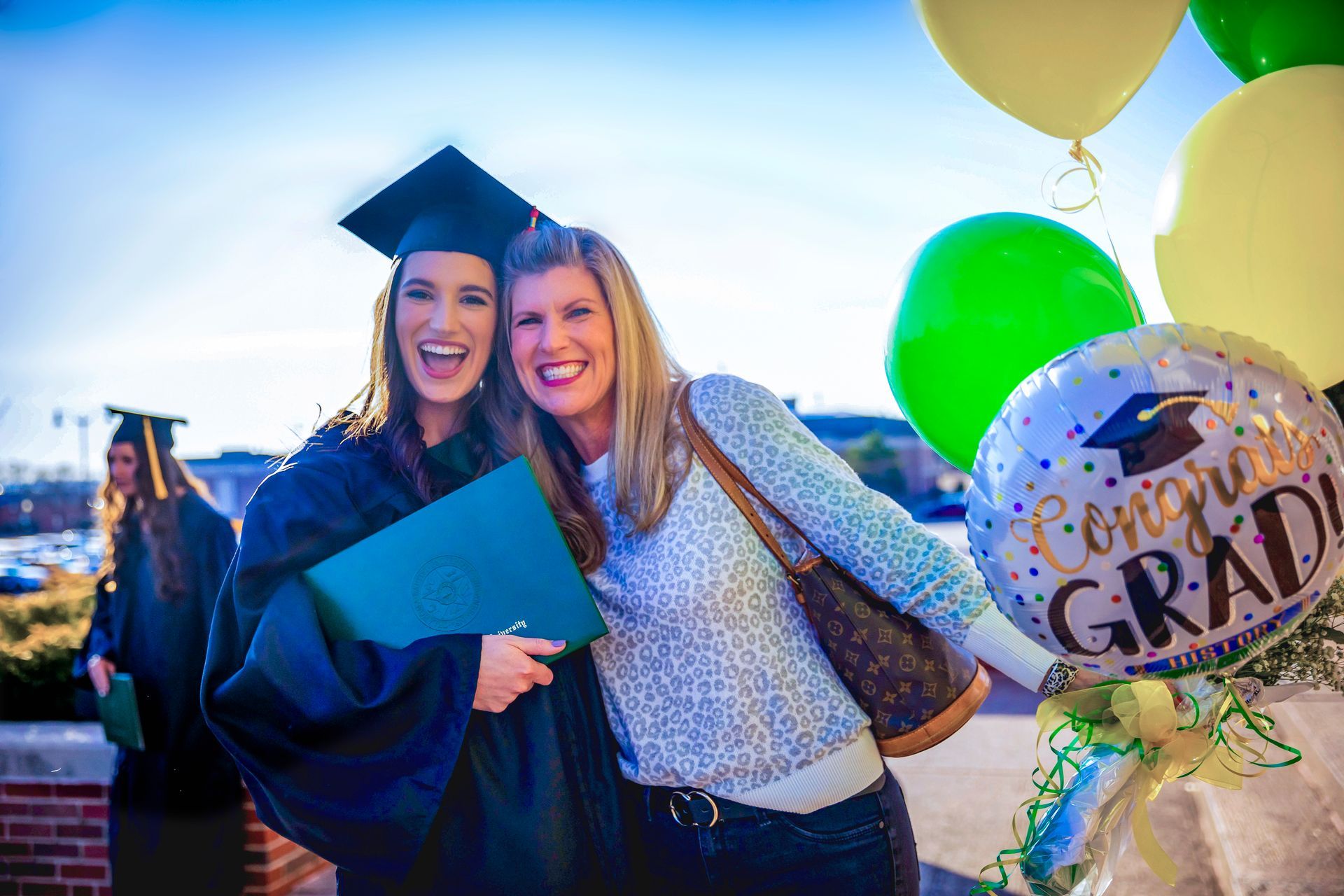 Graduate and parent celebrating