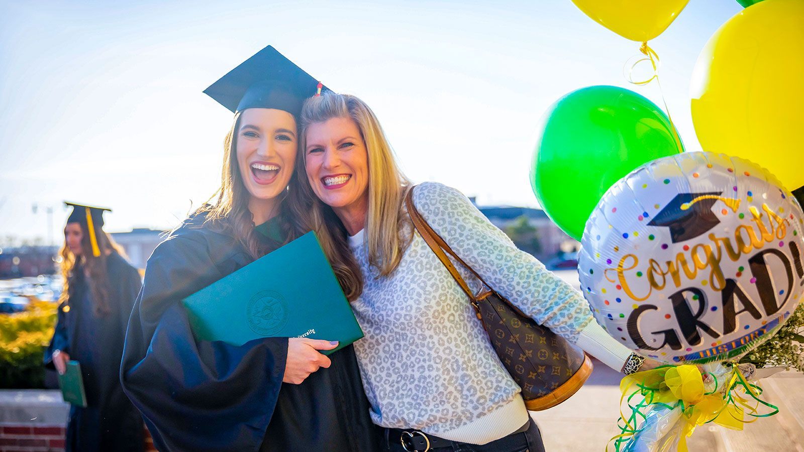 Graduate and parent celebrating