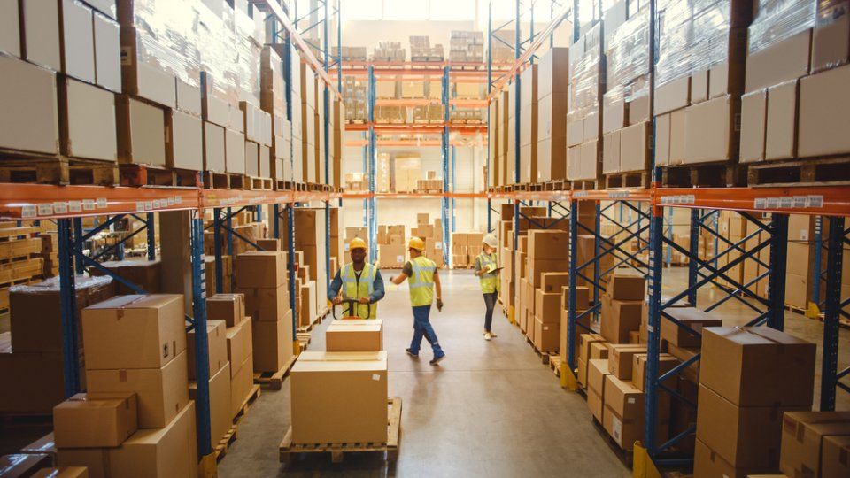 warehouse full of shelves with goods in cardboard boxes