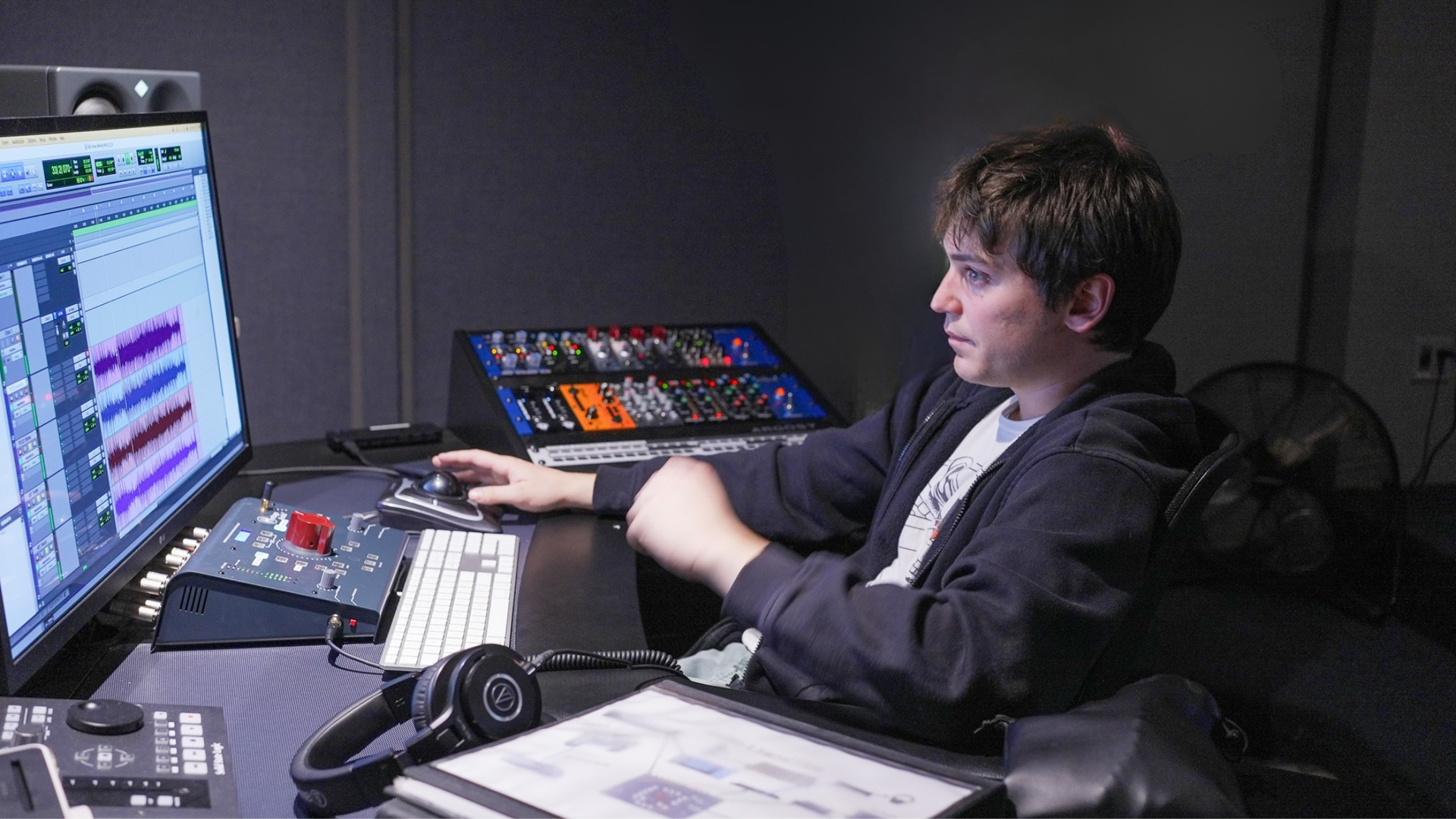 man working ons computer with sound for audio engineering