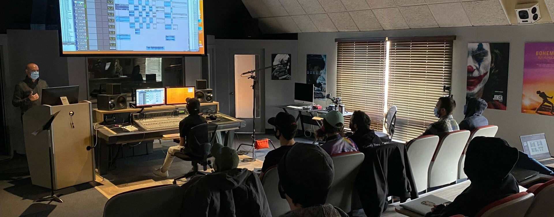 A man is giving a presentation to a group of people in a room.