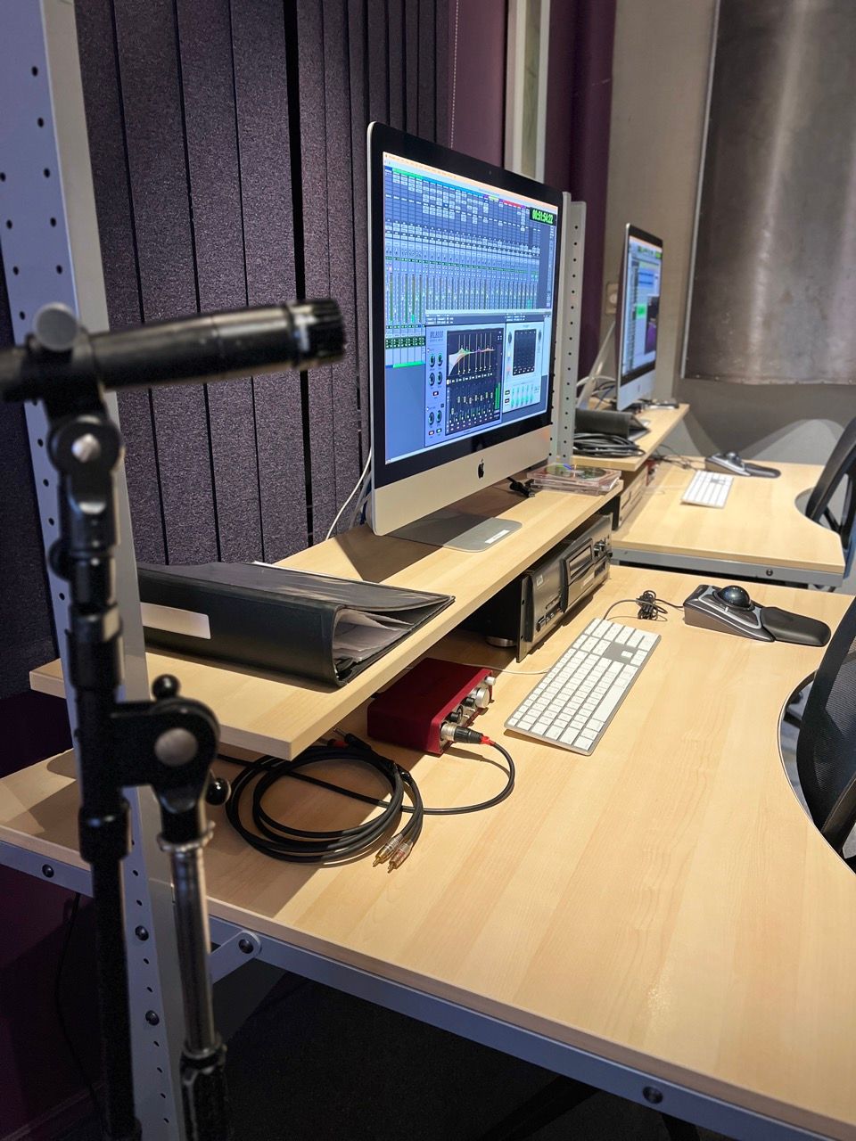 A desk with a computer and a microphone on it