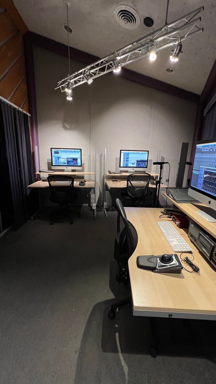 A room with a lot of computers on the desks