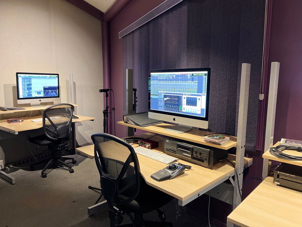 A room with two desks and two computer monitors on them
