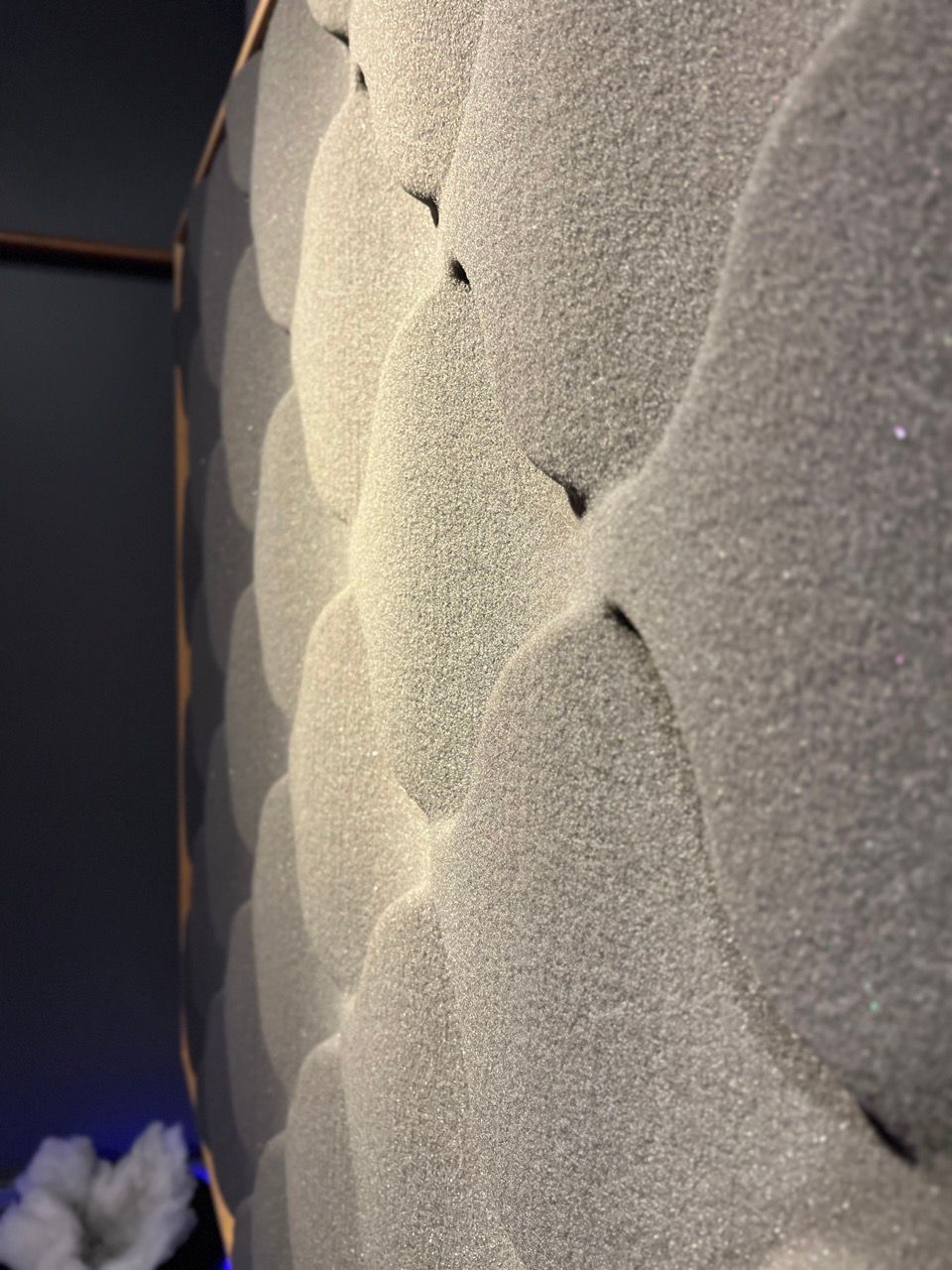 A close up of a white wall with circles on it.