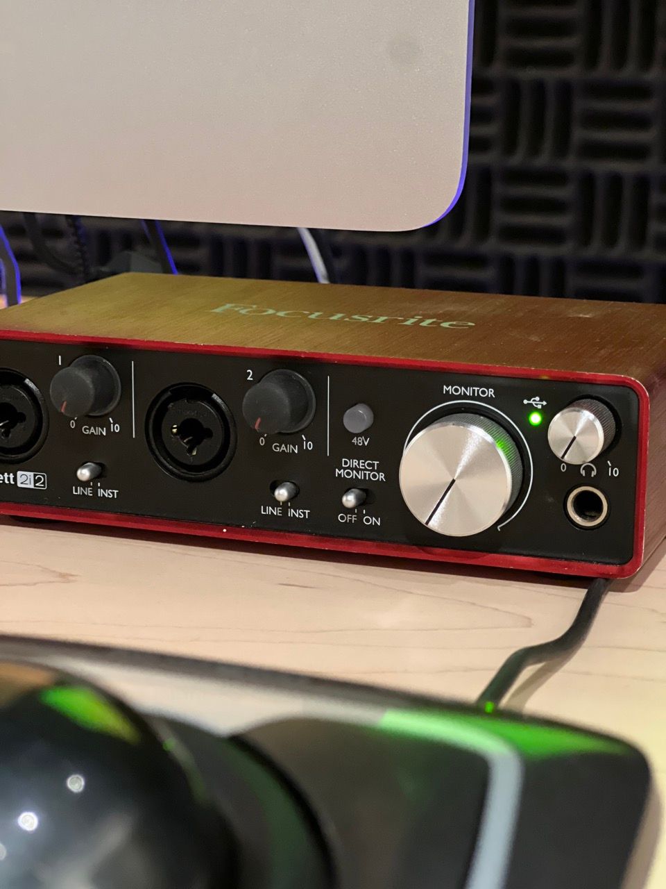 A sound card is sitting on a desk next to a computer