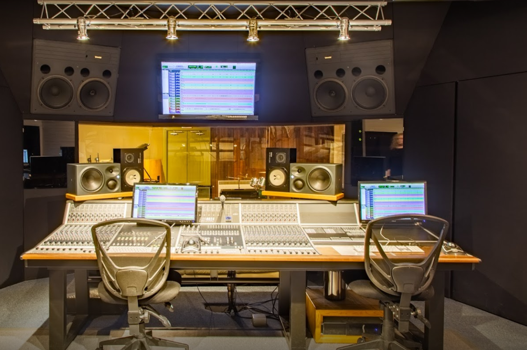 A recording studio with two desks and two chairs