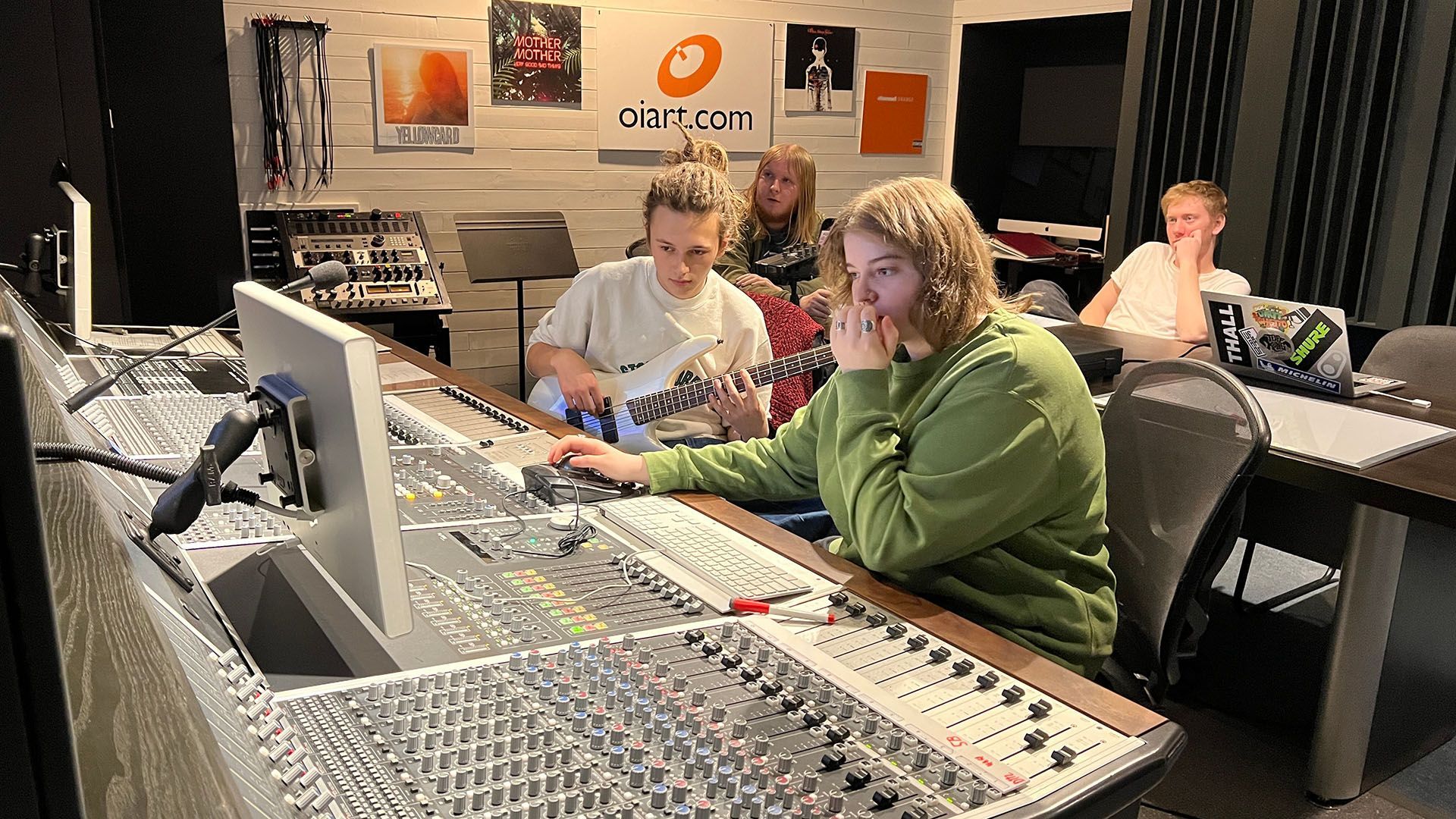audio engineering students mixing on a sound board