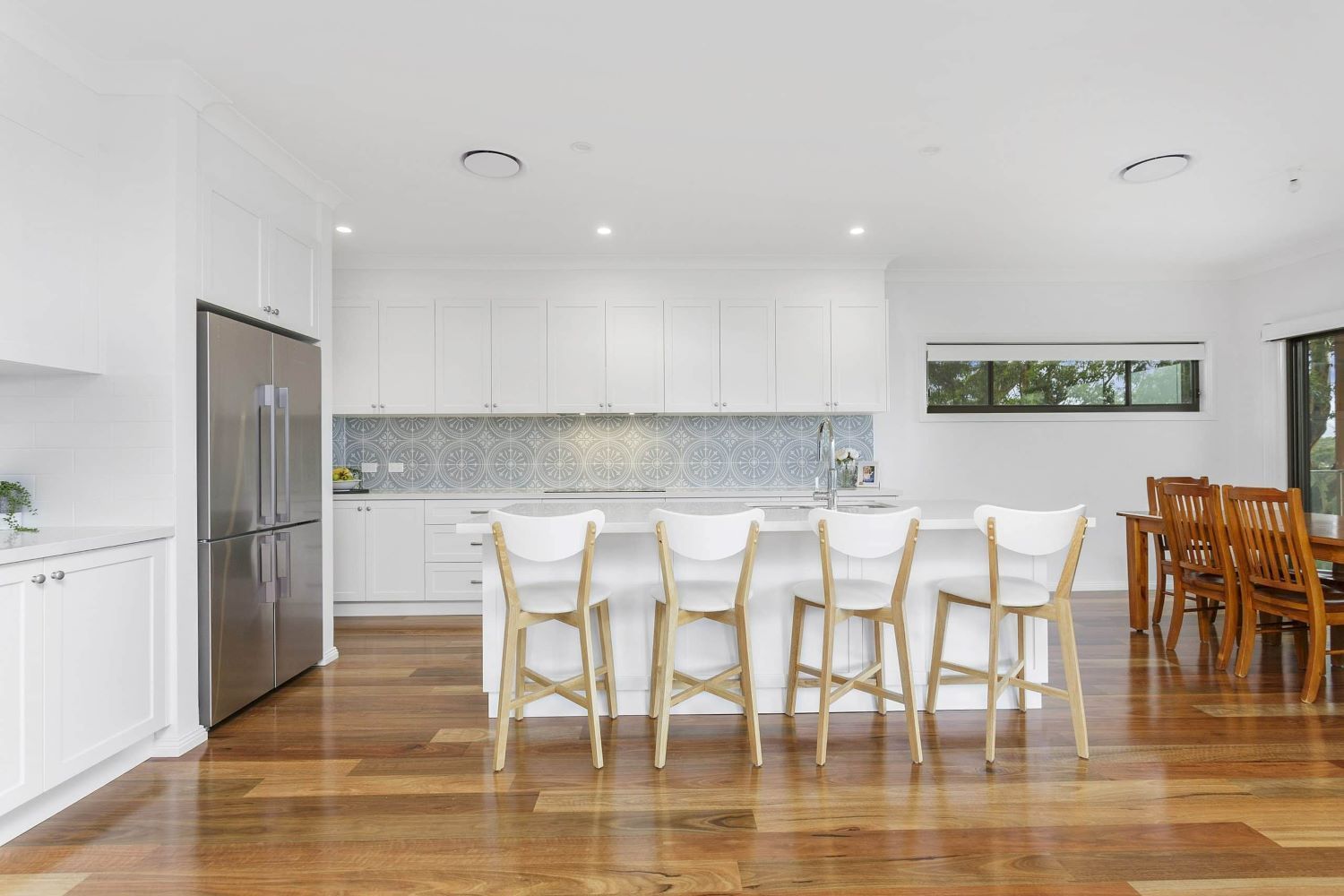 A Kitchen With White Cabinets and Stainless Steel Appliances — Evolution Building Group Dapto, NSW