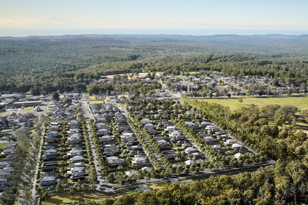 White House With a Garage, Green Lawn, and Tropical Plants Under a Twilight Sky — Evolution Building Group in Dapto, NSW