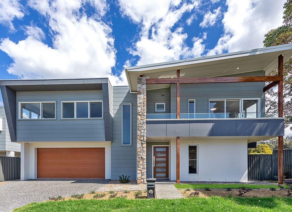 A Modern House With a Large Garage and a Balcony — Evolution Building Group Dapto, NSW