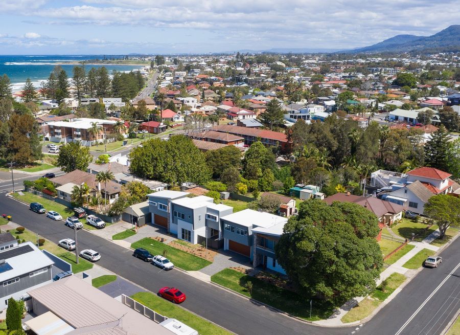 An Aerial View of a Residential Area With a Red Car Parked on the Side of the Road — Evolution Building Group Dapto, NSW