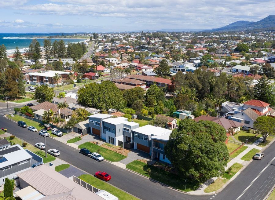 An Aerial View of a Residential Area With a Red Car Parked on the Side of the Road — Evolution Building Group Dapto, NSW