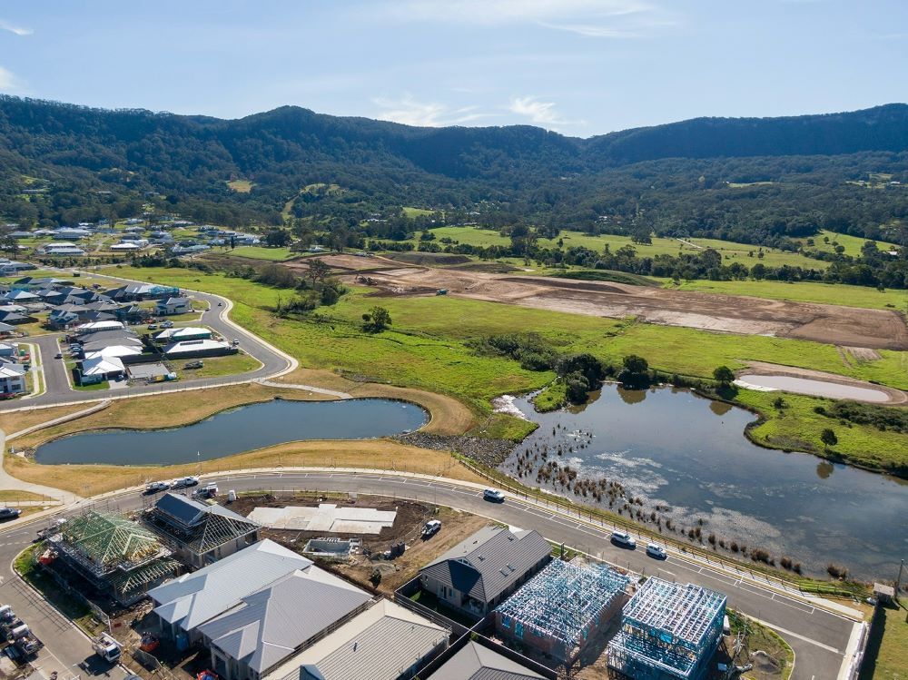 An Aerial View of a Residential Area With a Lake and Mountains in the Background — Evolution Building Group Dapto, NSW