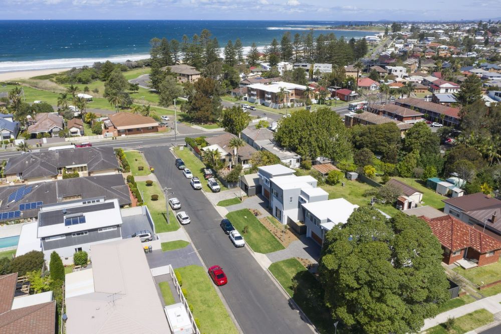 An Aerial View of a Residential Area With a Red Car Parked on the Side of the Road — Evolution Building Group Dapto, NSW
