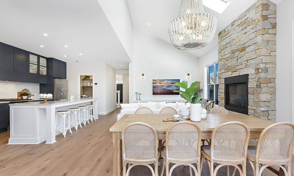 A Dining Room Table and Chairs in a House With a Fireplace — Evolution Building Group Dapto, NSW