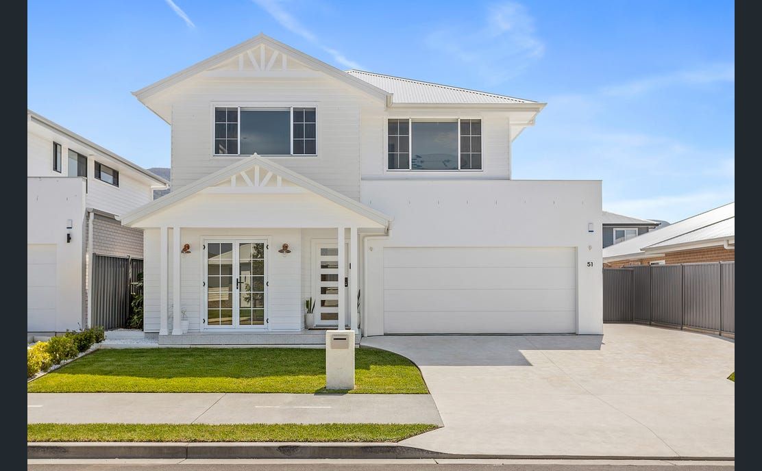 White Two-Story House With a Garage and Lawn — Evolution Building Group in Dapto, NSW