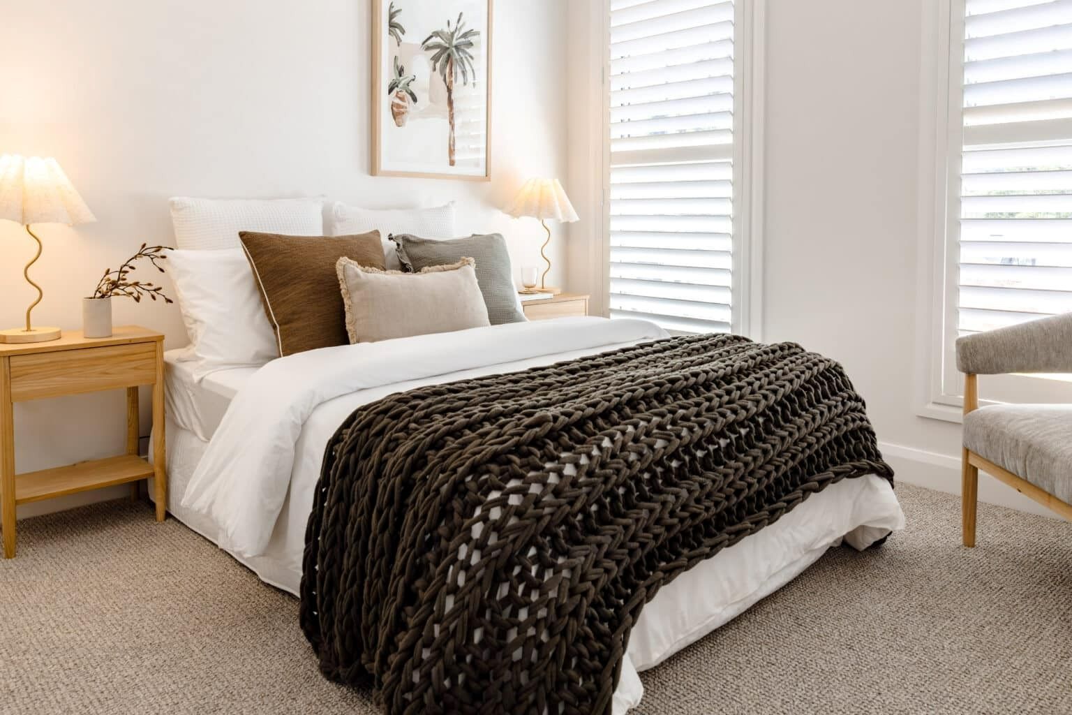A Bedroom With a Bed, Chair, Nightstand and Shutters — Evolution Building Group Dapto, NSW