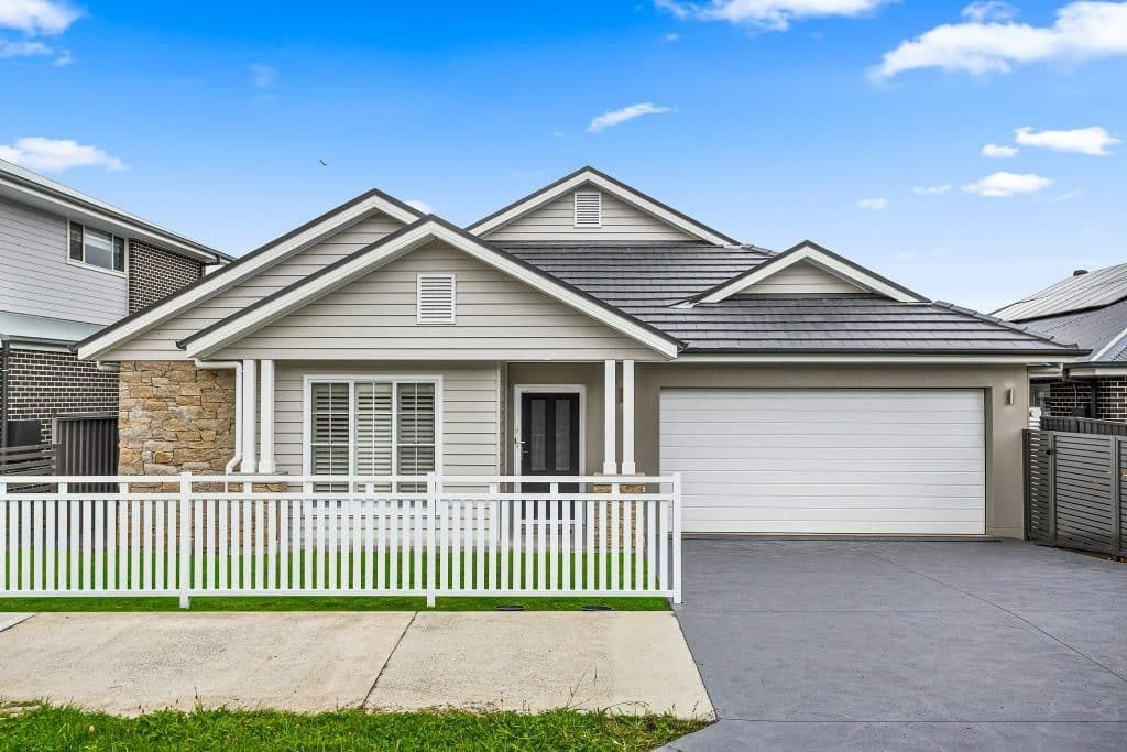 The front of A House with A White Picket Fence — Evolution Building Group Dapto, NSW
