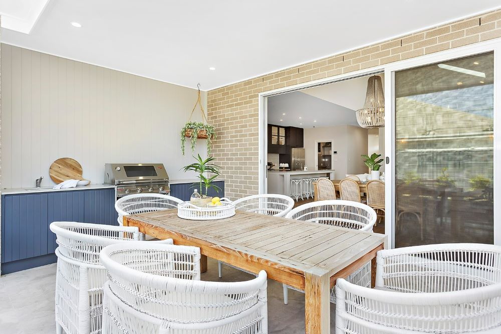 A Patio With a Table and Chairs and a Grill — Evolution Building Group Dapto, NSW
