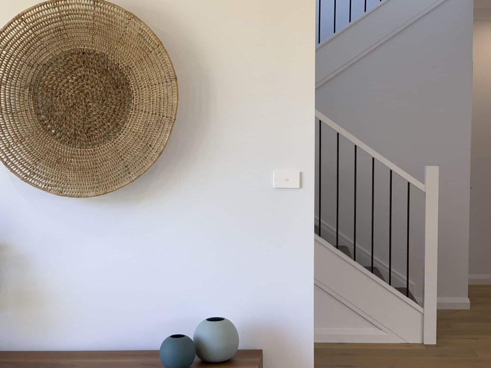 A Wicker Basket is Hanging on a Wall Next to a Staircase — Evolution Building Group Dapto, NSW