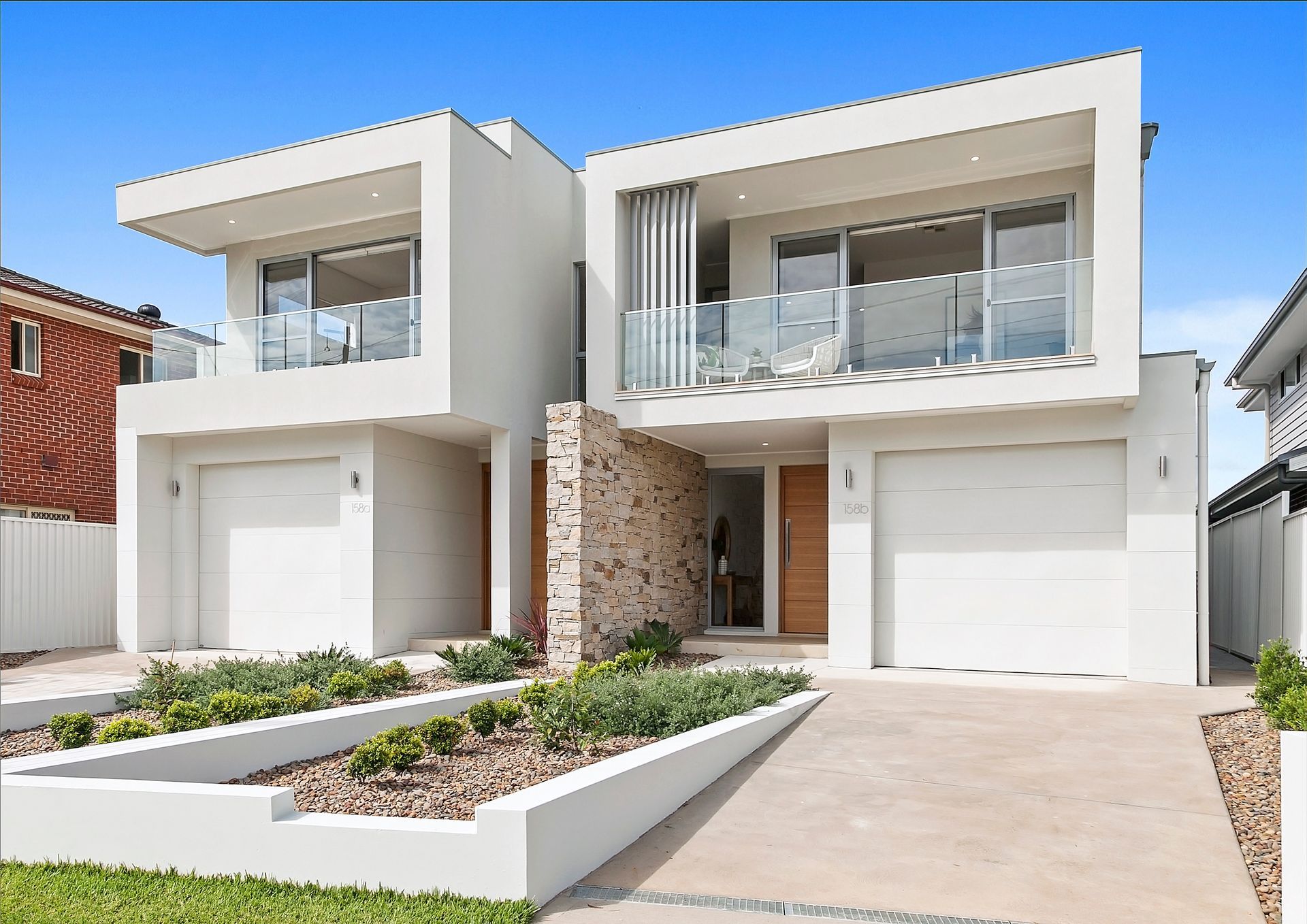 Two Modern, White Townhouses with Driveways and Minimalist— Evolution Building Group Dapto, NSW