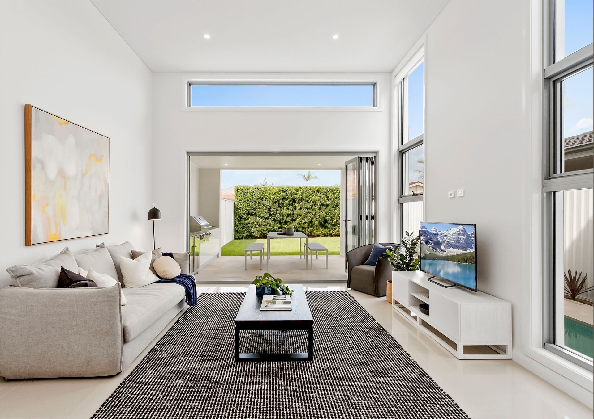 A Bedroom with A Large Bed and A Ceiling Fan — Evolution Building Group Dapto, NSW