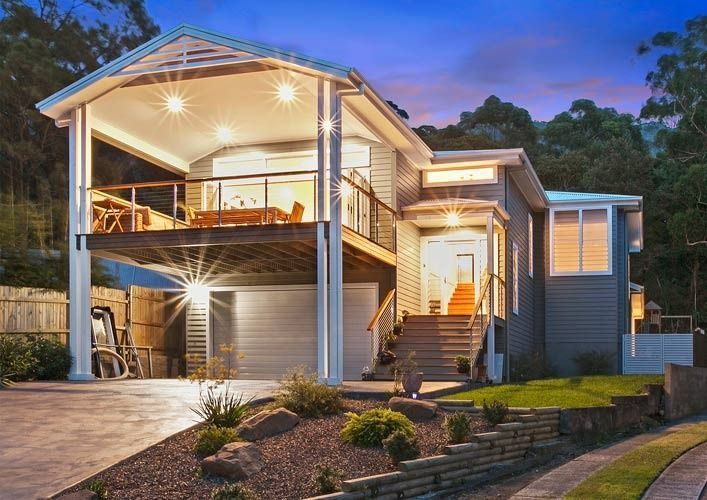A Large House With a Balcony and Stairs is Lit Up at Night — Evolution Building Group Dapto, NSW