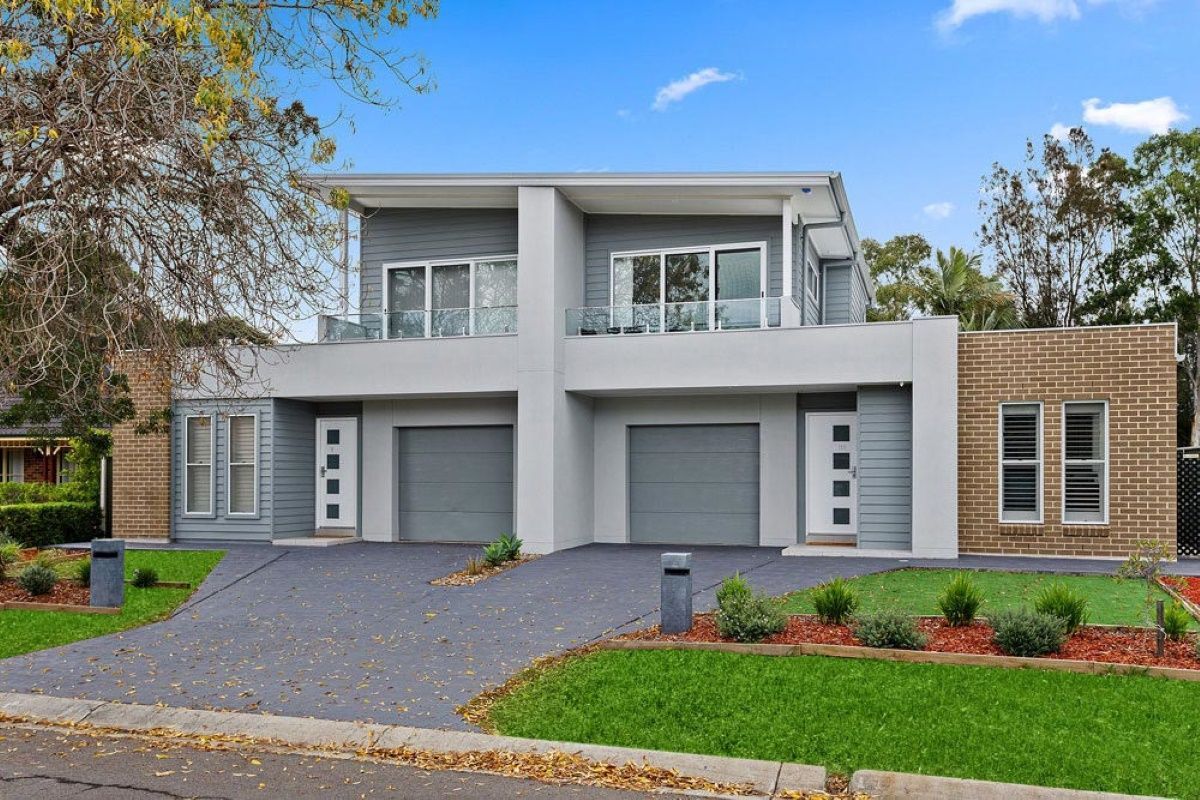 A Modern House With Two Garages and a Driveway — Evolution Building Group Dapto, NSW
