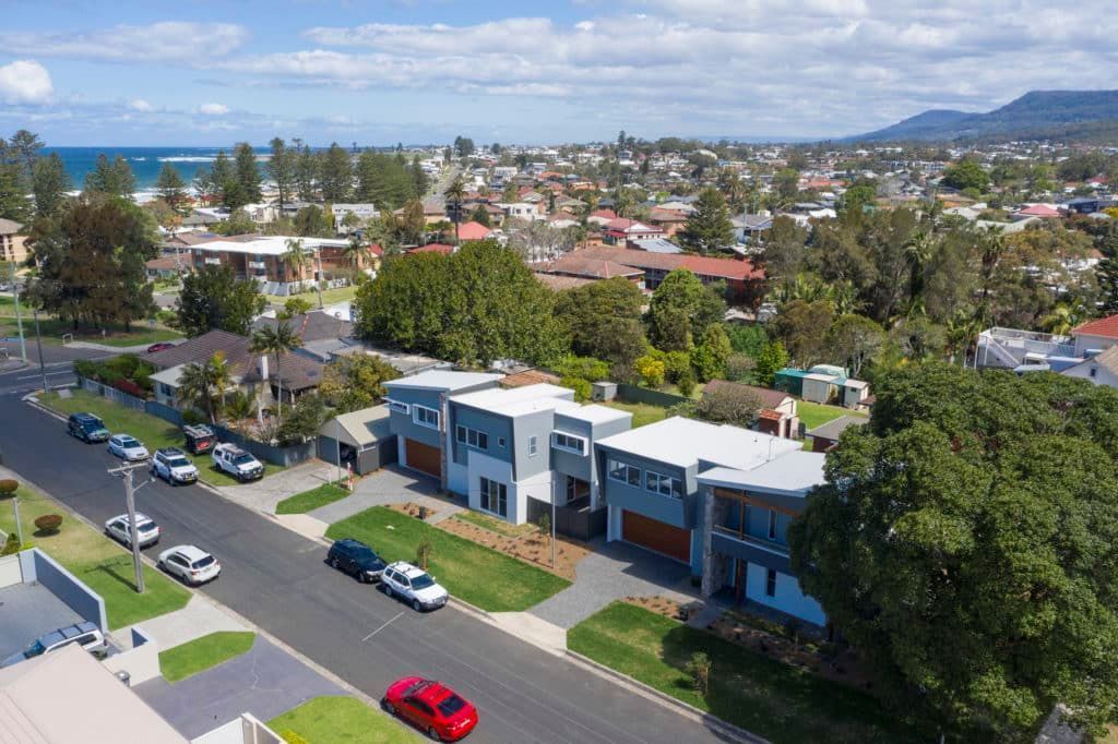 An Aerial View of A Residential Area with A Red Car Parked on The Side of The Road — Evolution Building Group Dapto, NSW