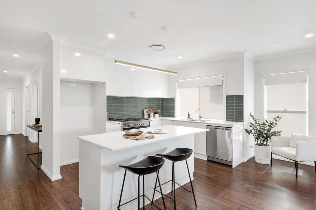 A Kitchen With White Cabinets, and a Large Island — Evolution Building Group Dapto, NSW
