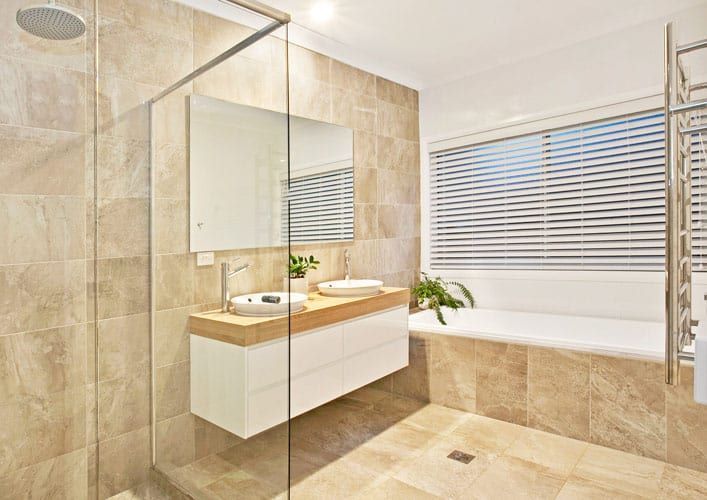 A Bathroom with A Walk in Shower, Sink, Mirror and Bathtub — Evolution Building Group Dapto, NSW