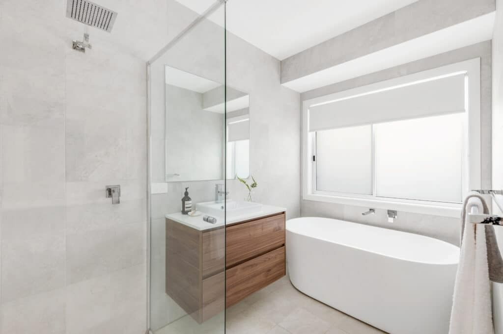 A Bathroom with A Bathtub, Sink, Shower and Window — Evolution Building Group Dapto, NSW