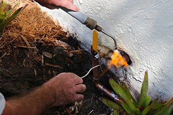 Plumber fixing and repairing the outside faucet pipes