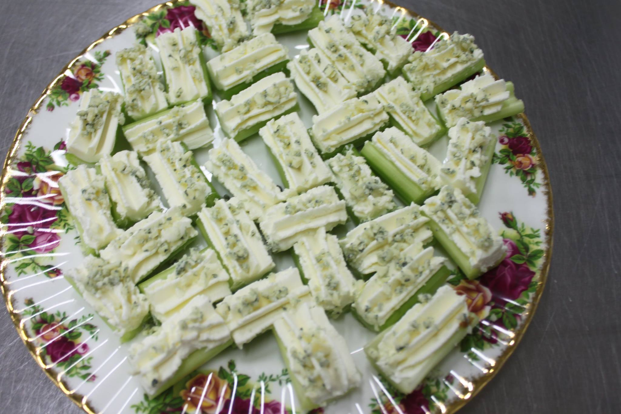 Celery sticks filled with cream cheese topped with Harrogate blue cheese canapes.