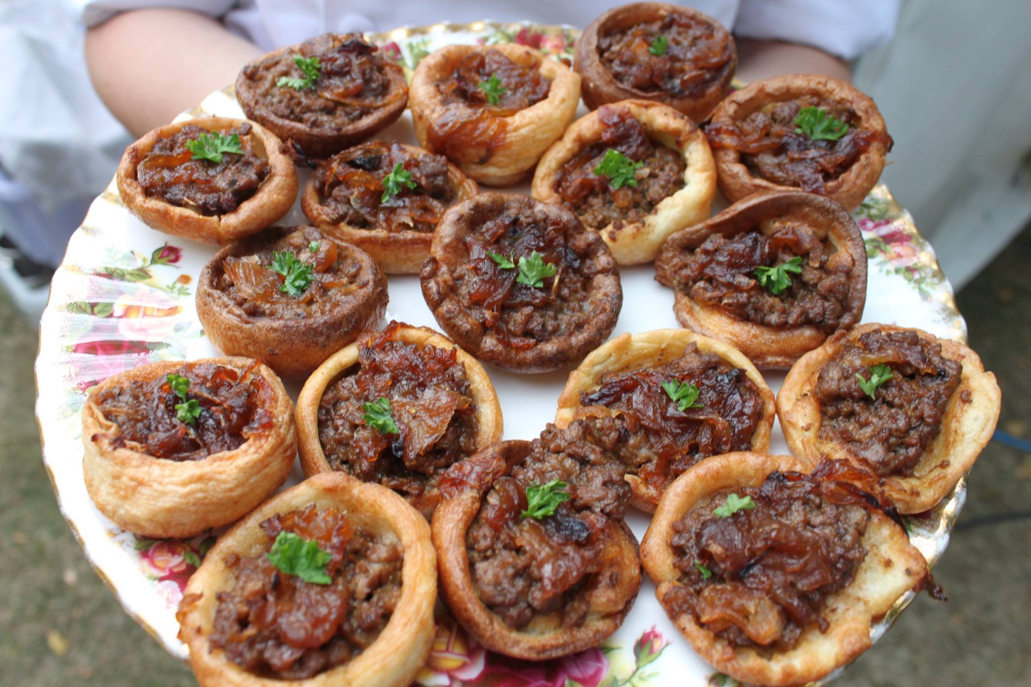 Homemade Yorkshire puddings filled with best minced beef and topped with caramelized onions canapes.