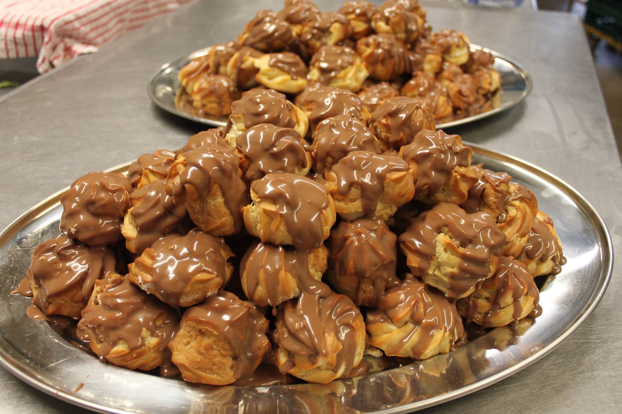 Chocolate profiteroles that will be served with fresh double cream.